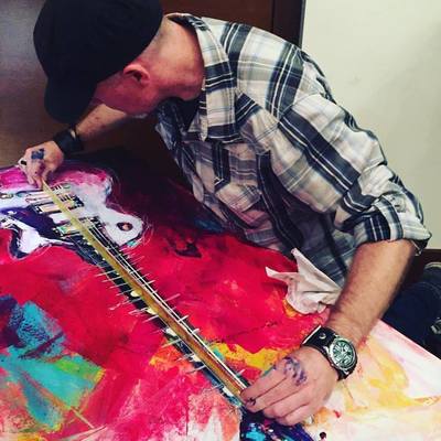 Roy Laws art, Painter of Music, live entertainment; live painting a guitar, adding strings; Nashville, TN
