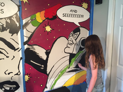 Kids filling in color of retro comic wall mural; Bohemian Rhapsody lyrics; Roy Laws art, Painter of Music, live entertainment